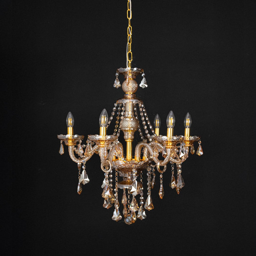 Crystal-chandelier with lights off showcasing glass details and design on black background.