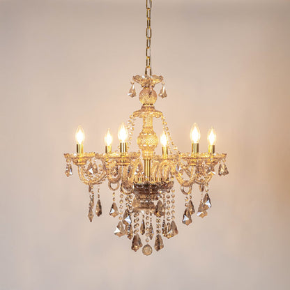 Crystal-chandelier ceiling light turned on with sparkling glow on white background.