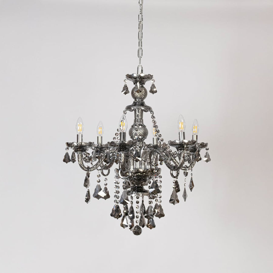 Classic chandelier with lights off on white background showing detailed crystal and metal design.