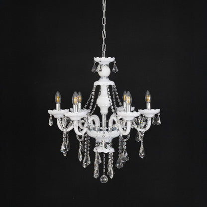 Chandelier with lights off highlighting glass and crystal design details photographed on black background.
