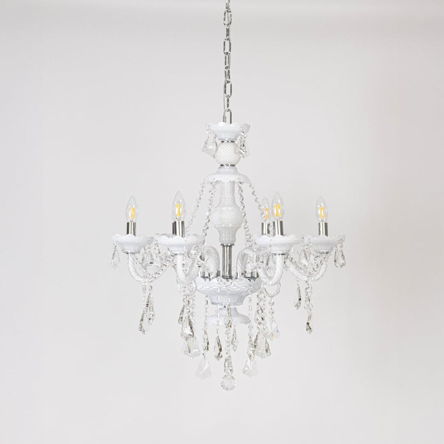 Chandelier with lights off showcasing crystal and glass frame design on plain white background for home interiors.