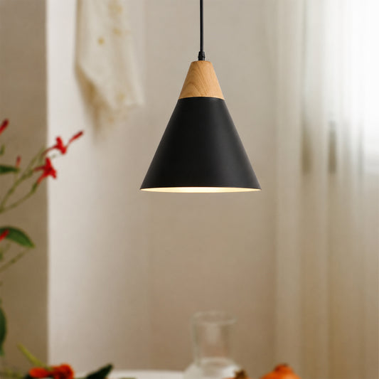 A modern cone-shaped pendant light with a matte black metal shade and a natural light wood cone accent at the top, hanging in a softly lit interior setting.