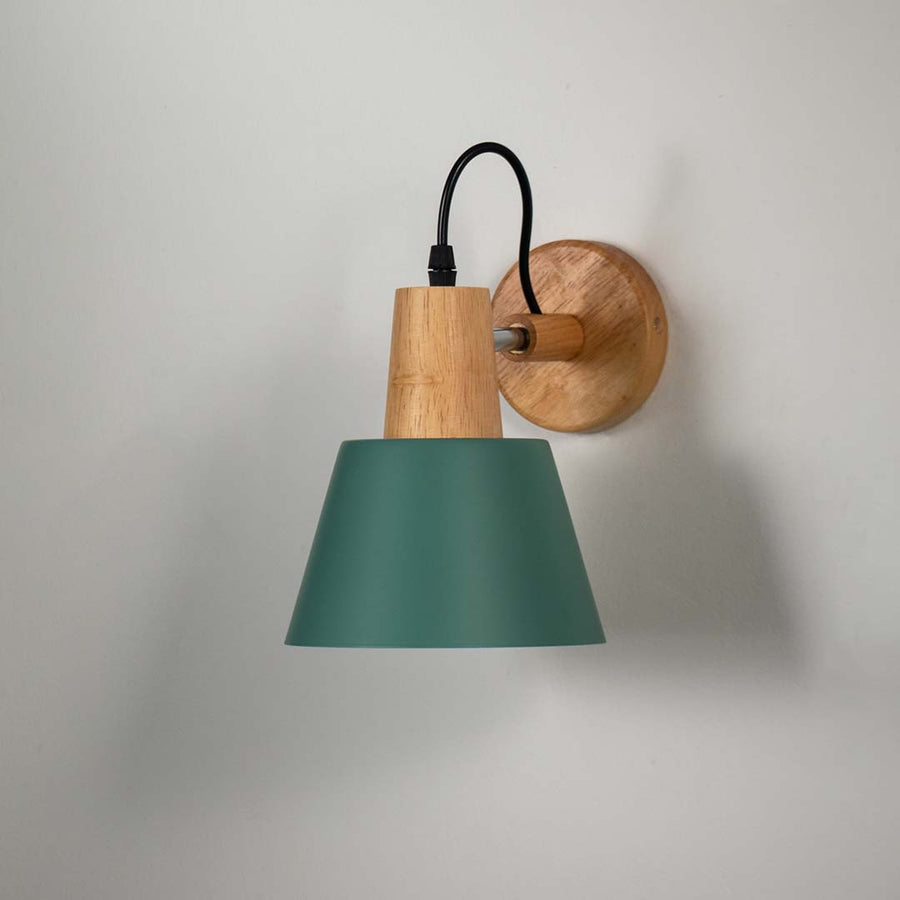Modern green metal and wooden wall light for stylish bedroom and Scandinavian decor styling spaces.