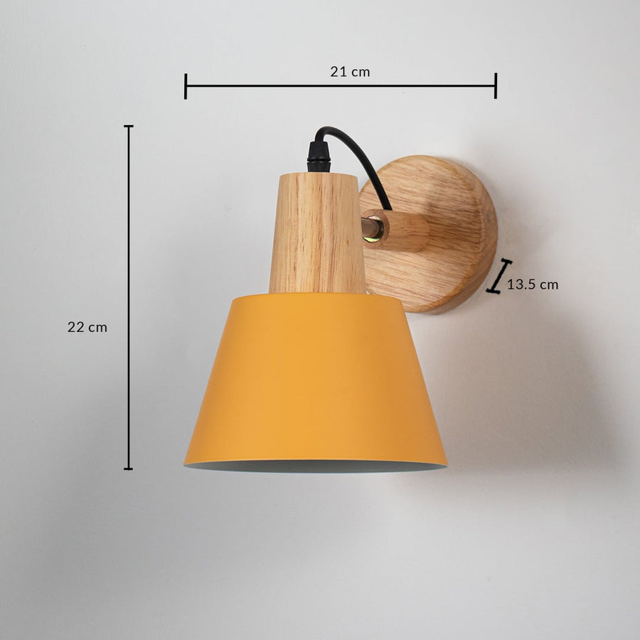 Wall lamp with matte mustard yellow shade wooden base and black cord shown with size 22 cm height 21 cm width and 13.5 cm depth.