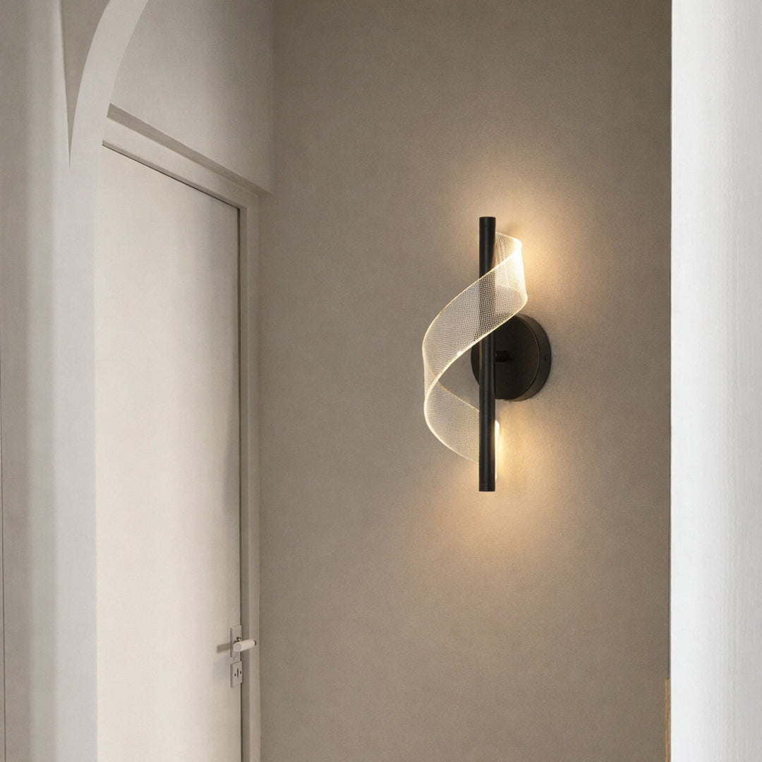 Modern gold metal wall light with warm ambient glow for elegant hallway and luxury decor spaces.

