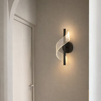Modern gold metal wall light with warm ambient glow for elegant hallway and luxury decor spaces.

