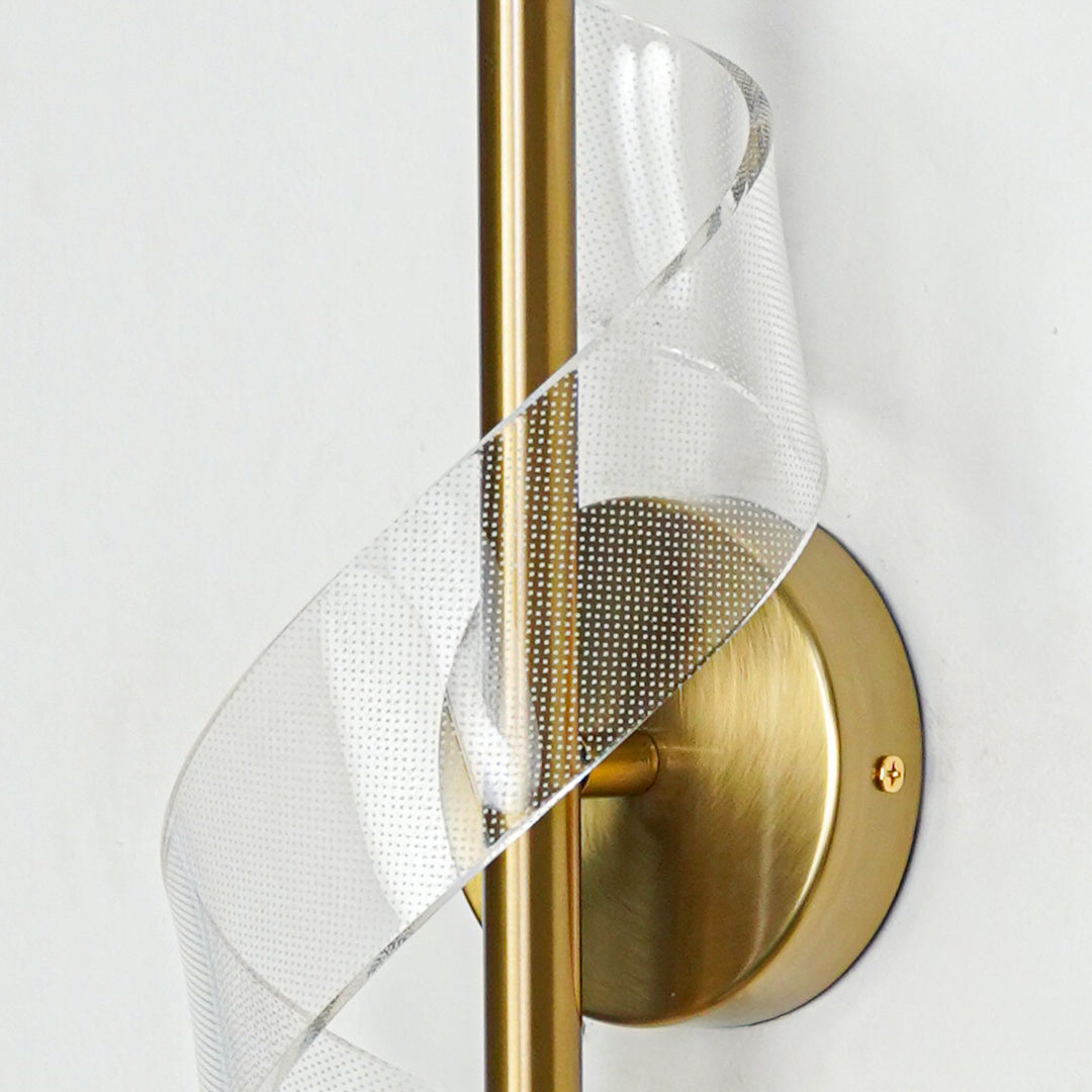 Closeup of gold metal and translucent mesh wall light for premium modern decor styling spaces.