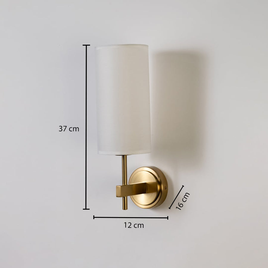 Gold metal wall light with tall white fabric shade shown with 37 cm height 12 cm width and 16 cm depth for accurate indoor wall placement.