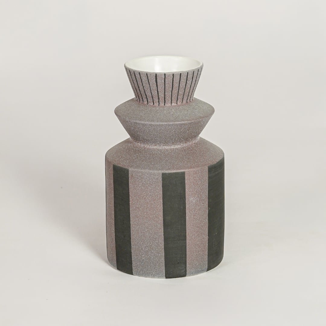 Erebus ceramic vase with striped textured body and sculpted neck isolated on clean white background for modern decor styling.