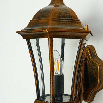 Close view of bronze outdoor wall light with glass panels showcasing durable weather resistant classic lighting design.

