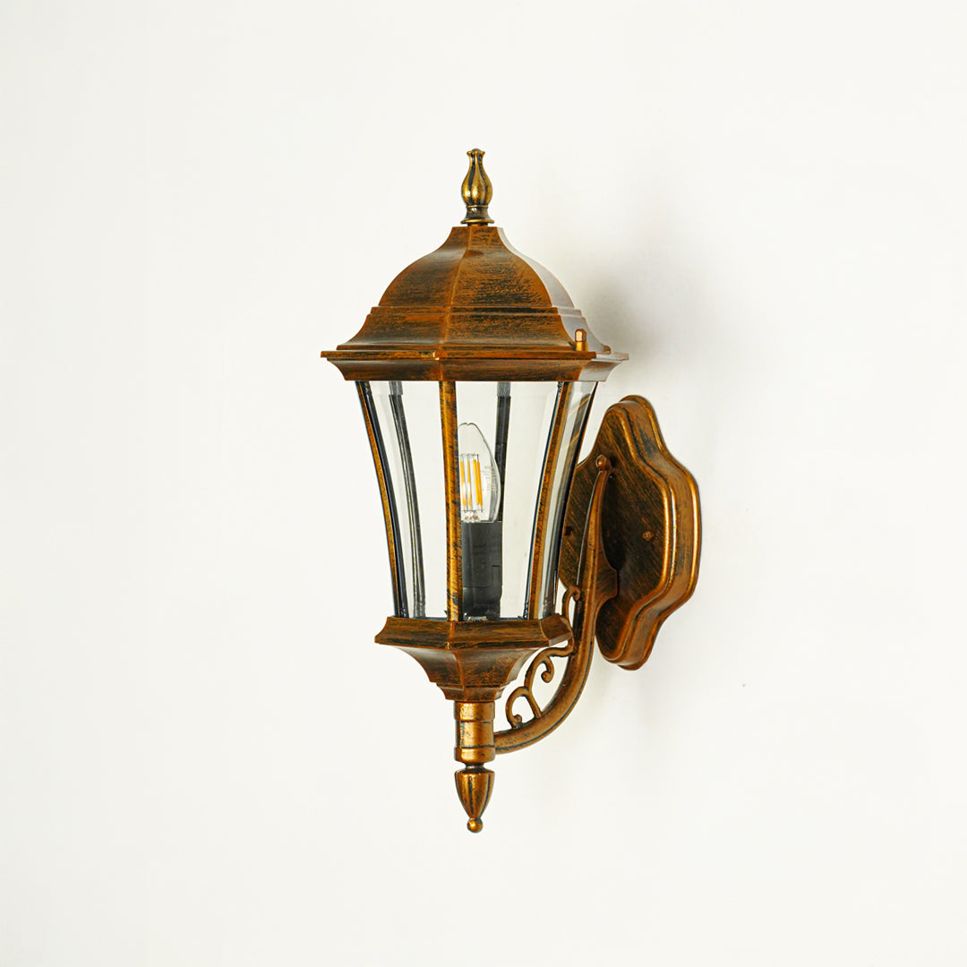Traditional outdoor wall lantern with decorative metal detailing and clear glass panels perfect for exterior home lighting design.