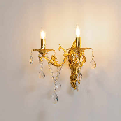 Gold metal crystal wall light on white background with candle style bulbs for elegant vintage wall decor.