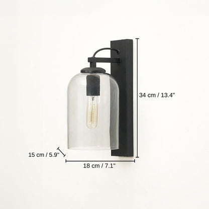 Black wall-mounted sconce with a clear glass bell shade and visible filament bulb, base 34 x 18 x 15 cm (13.4 x 7.1 x 5.9 inches), canopy 34 x 7 cm (13.4 x 2.8 inches) dimensions