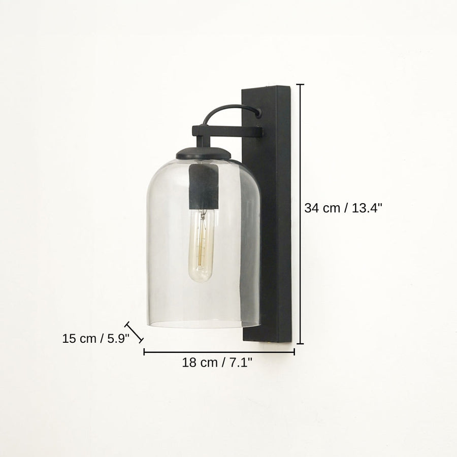 Black wall-mounted sconce with a clear glass bell shade and visible filament bulb, base 34 x 18 x 15 cm (13.4 x 7.1 x 5.9 inches), canopy 34 x 7 cm (13.4 x 2.8 inches) dimensions