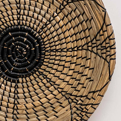 Closeup of handwoven seagrass basket showing intricate black circular woven weave texture for living room wall art decor.