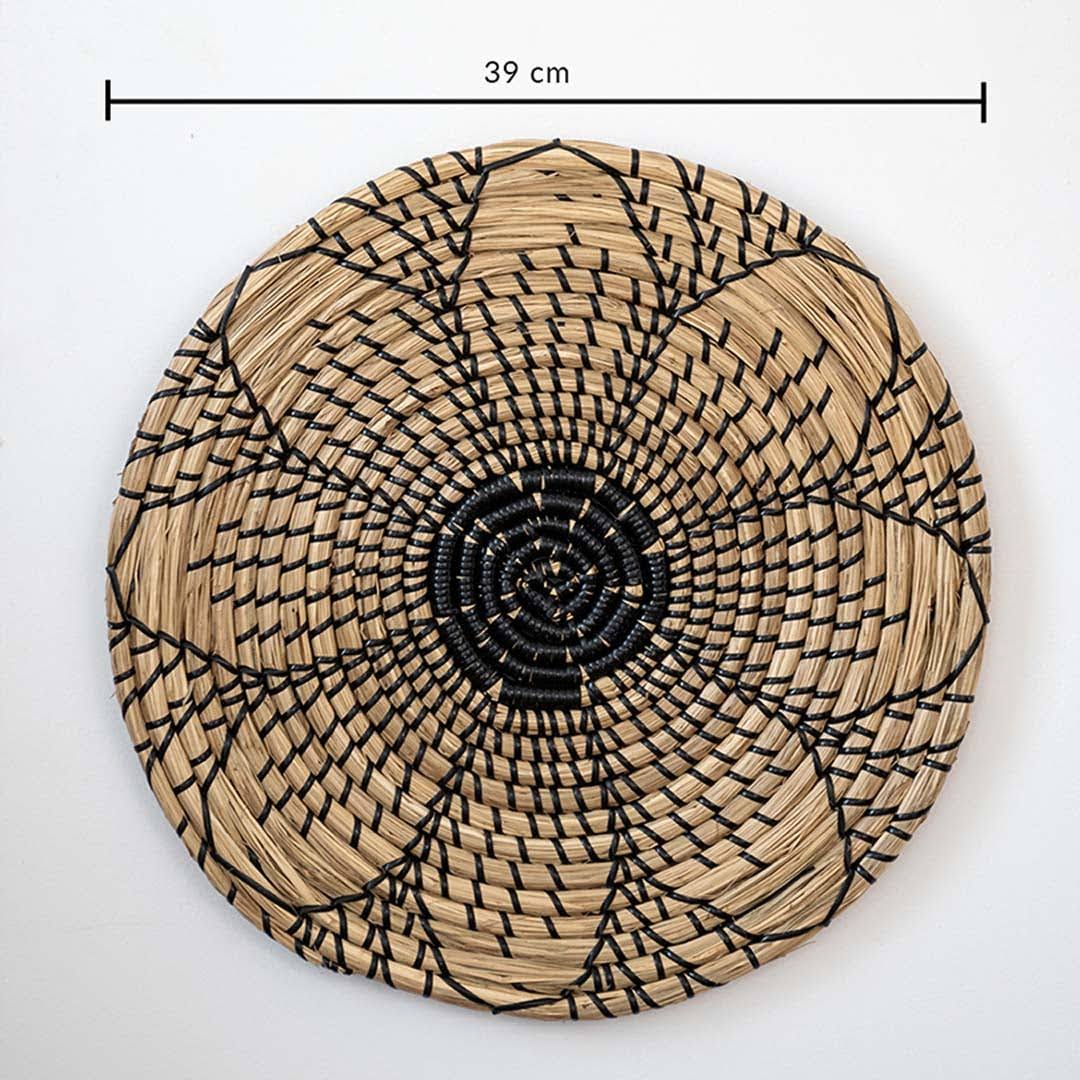 Natural handwoven seagrass basket wall decor with black flower pattern and dimension measurement for bohemian home styling.