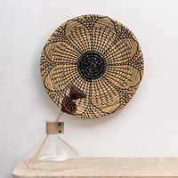 Handwoven wicker basket wall decor styled with minimal vase for rustic and boho inspired interiors and modern wall decoration.