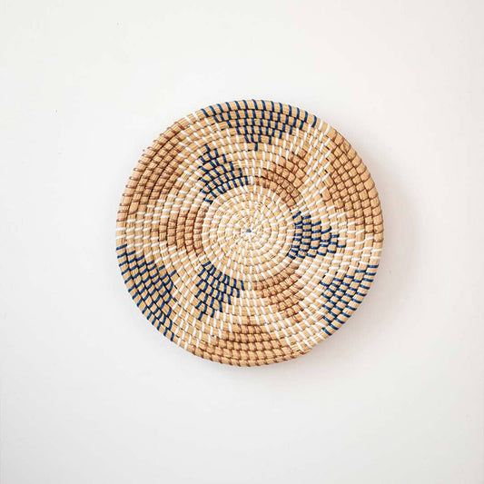 Aztec star geometric patterned black and beige woven seagrass wall hanging basket plate decoration isolated on white.