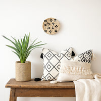Small woven wall basket placed above wooden bench with plant and cushions adding cozy handcrafted charm to living room Decor.