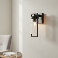 Modern black metal wall light with warm glow for stylish hallway and contemporary home decor spaces.