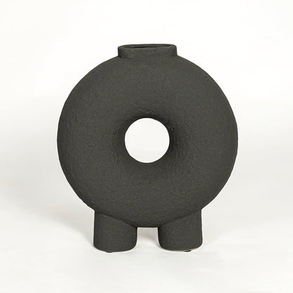 Modern black ceramic statement donut vase with hollow center for coffee table console or shelf styling.