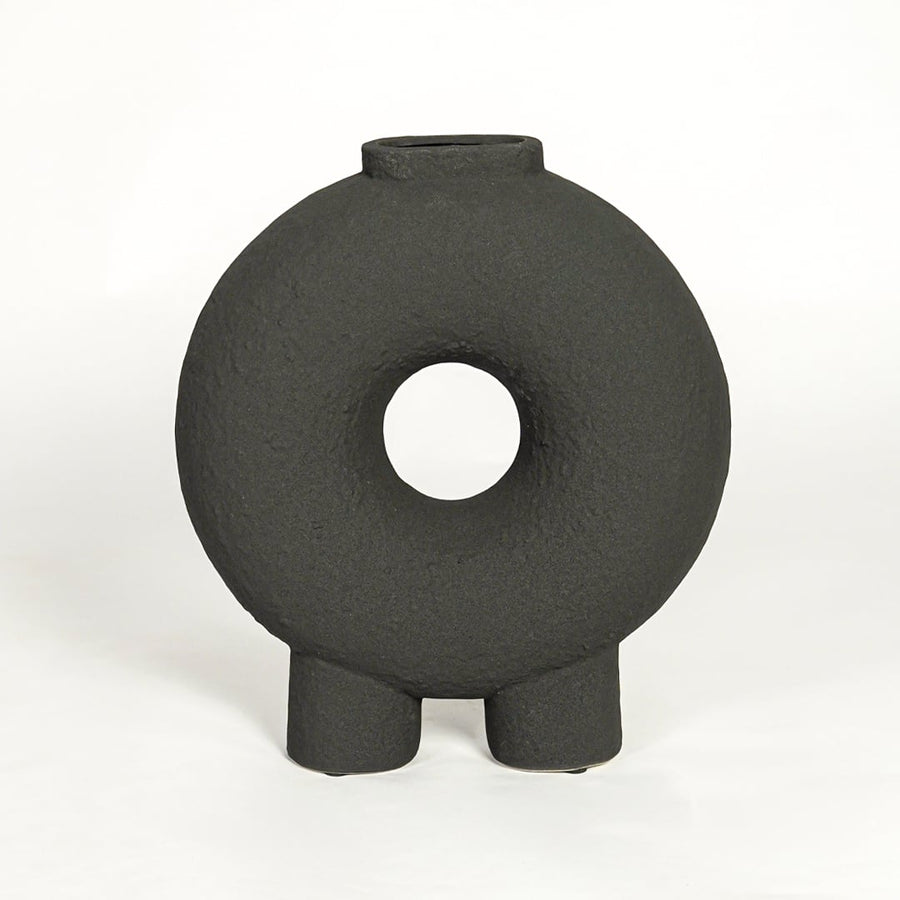 Modern black ceramic statement donut vase with hollow center for coffee table console or shelf styling.