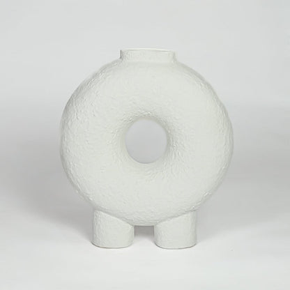 White ceramic donut vase with textured finish and round hollow center isolated on clean white background for modern decor styling.