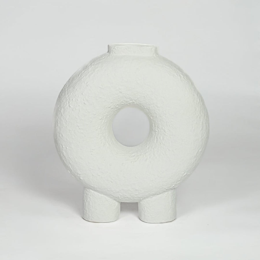 White ceramic donut vase with textured finish and round hollow center isolated on clean white background for modern decor styling.