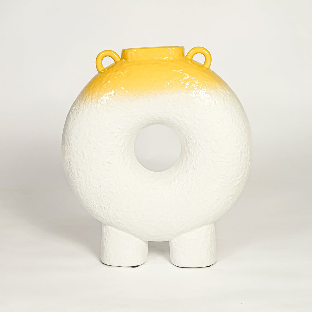 Modern white ceramic statement donut vase with yellow accent glaze for coffee table console or shelf styling.