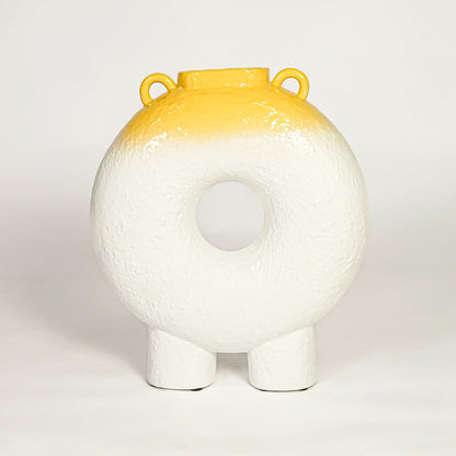 Modern white ceramic statement donut vase with yellow accent glaze for coffee table console or shelf styling.