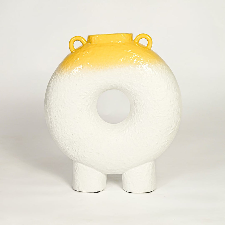 Modern white ceramic statement donut vase with yellow accent glaze for coffee table console or shelf styling.