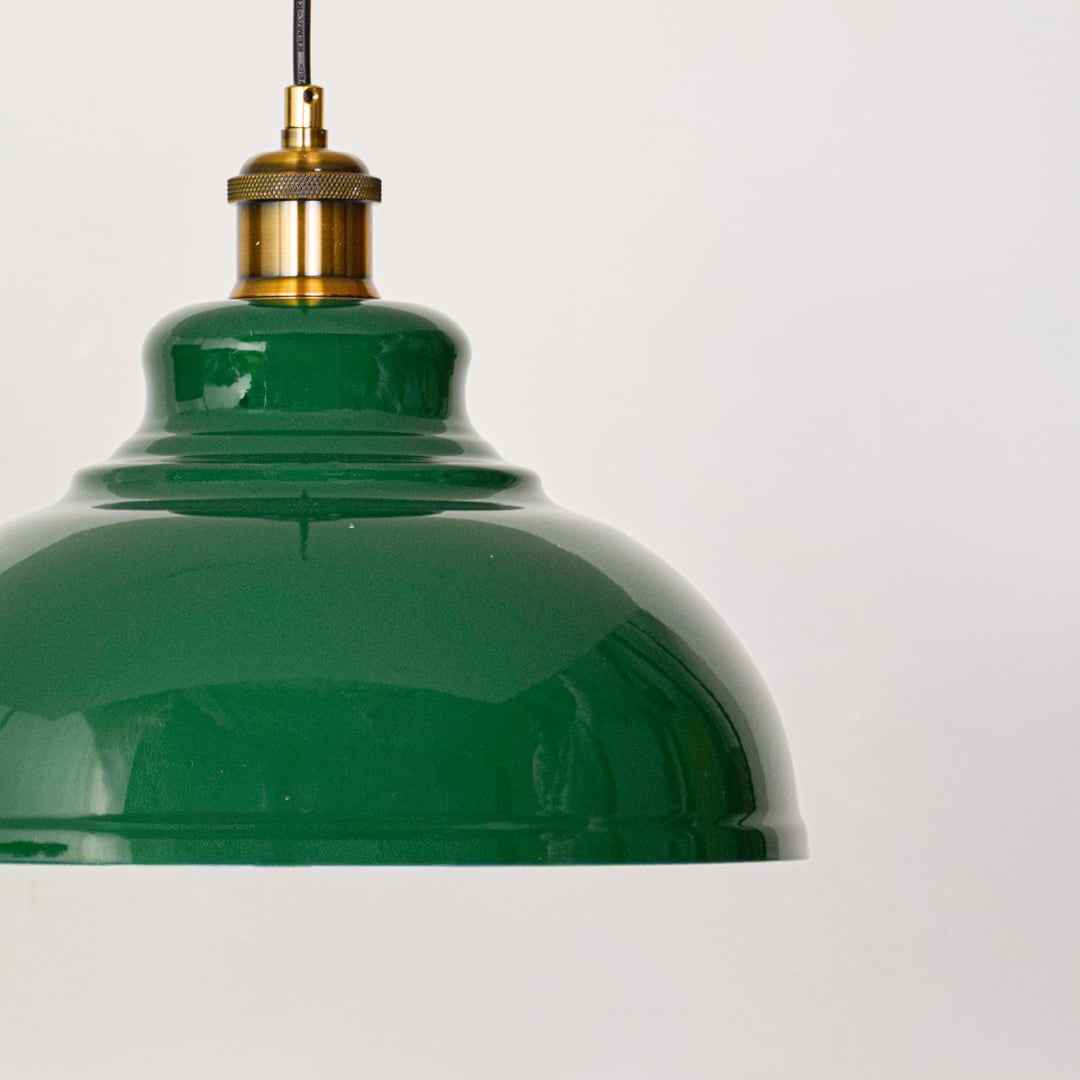 Detailed closeup of modern green metal pendant light with brushed gold holder highlighting refined finish elegant design and indoor wall placement.