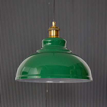 Green metal pendant ceiling light displayed on black background turned off highlighting glossy dome shade gold holder and clean modern design.