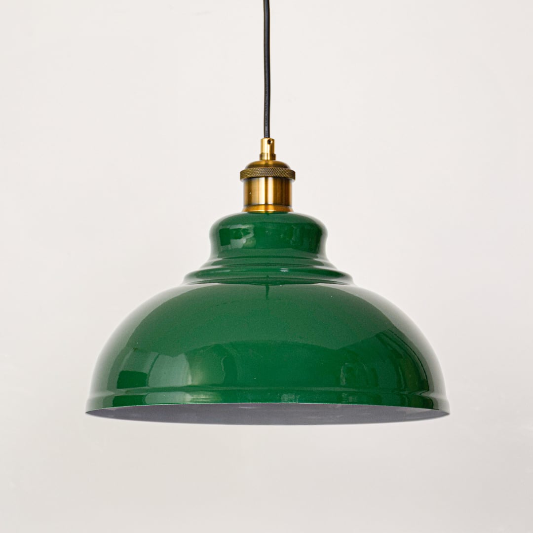 Green dome metal hanging lamp with golden brass holder displayed on white wall perfect for elegant home lighting.
