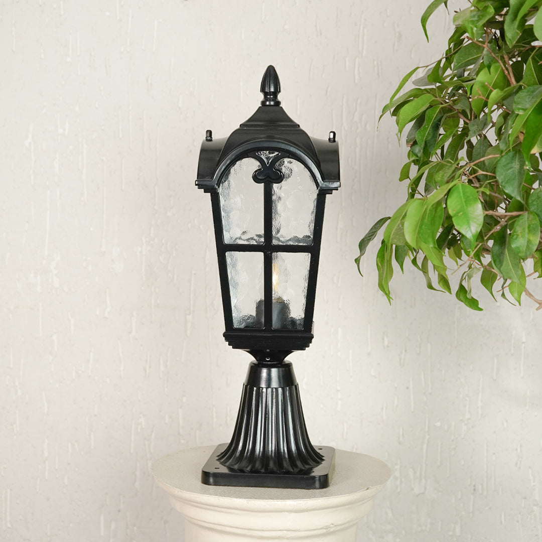Vintage black outdoor gate light with textured glass panels for elegant exterior decor use.