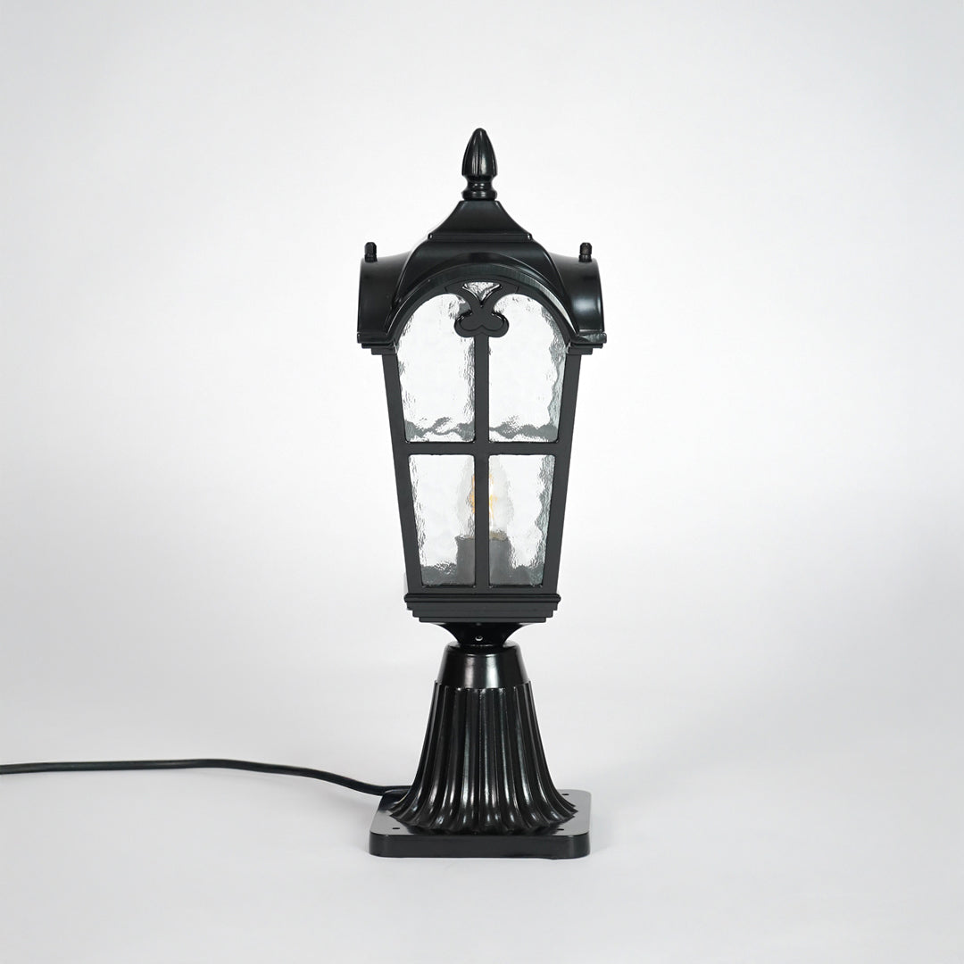 Vintage black outdoor gate light with textured glass panels for elegant exterior decor use.
