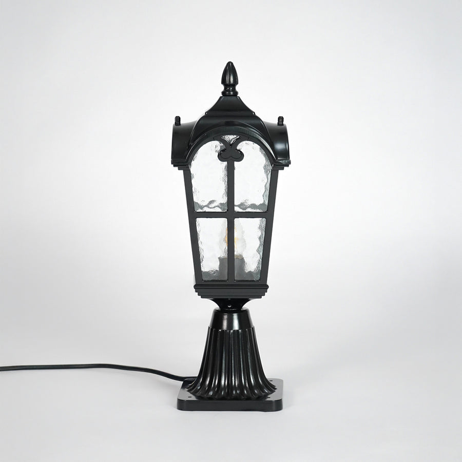 Vintage black outdoor gate light with textured glass panels for elegant exterior decor use.