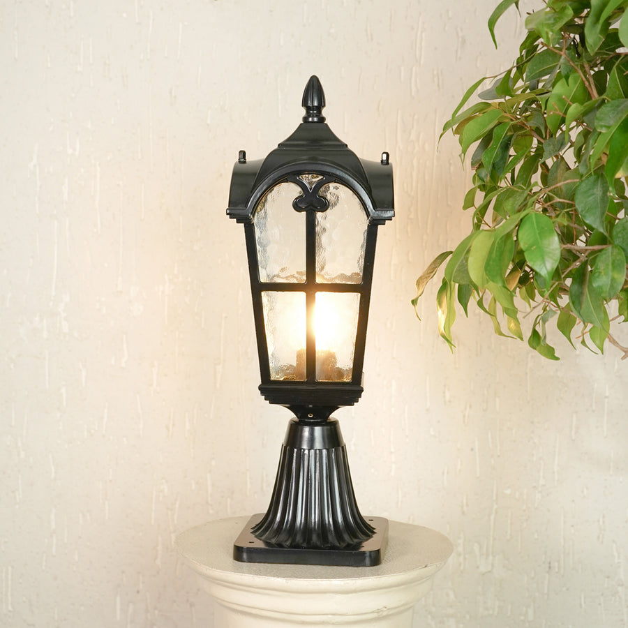 Classic black outdoor gate light with warm glowing bulb for stylish exterior decor styling use.