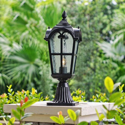 Classic black outdoor gate light styled among garden plants for luxury exterior decor ambiance.