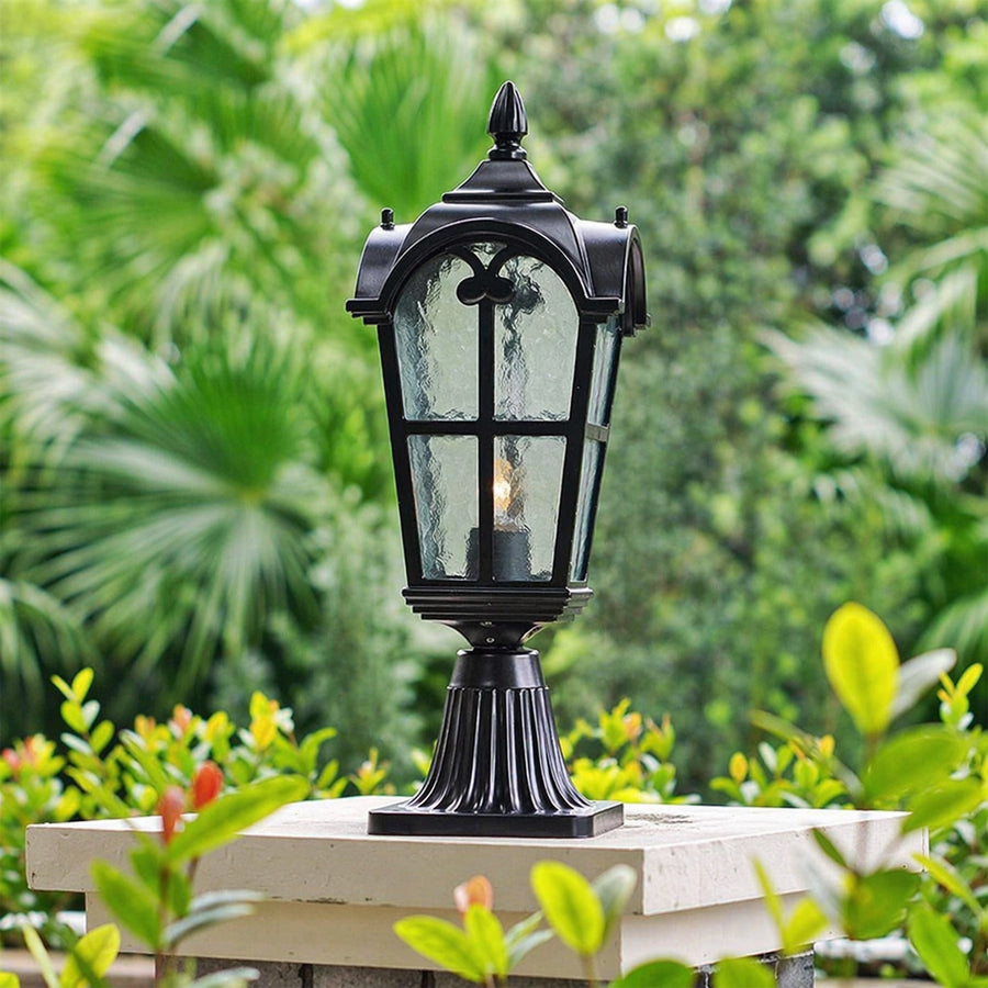 Classic black outdoor gate light styled among garden plants for luxury exterior decor ambiance.