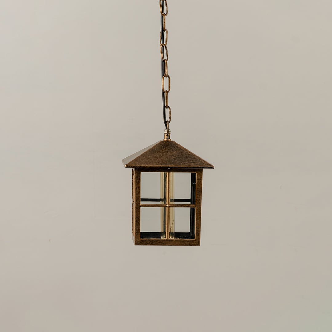 Unlit black metal globe hanging light fixture with decorative circular pattern cage isolated against a plain white background.