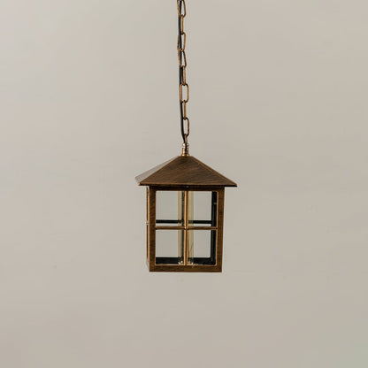 Unlit black metal globe hanging light fixture with decorative circular pattern cage isolated against a plain white background.