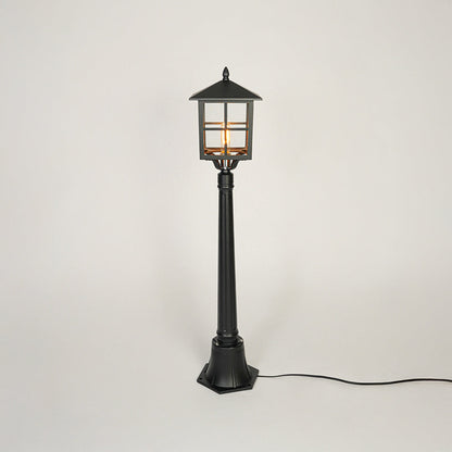 Classic black metal garden lamp post with clear glass panels on neutral background perfect for outdoor pathway or driveway lighting.