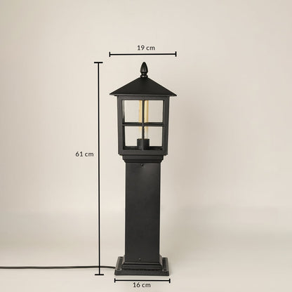Outdoor garden pillar lamp with black metal body and glass panels showing 62 cm height and 18 cm base width for exterior placement.