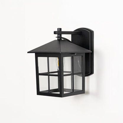 Black metal wall lantern switched off on white background highlighting square frame clear glass and modern outdoor design.