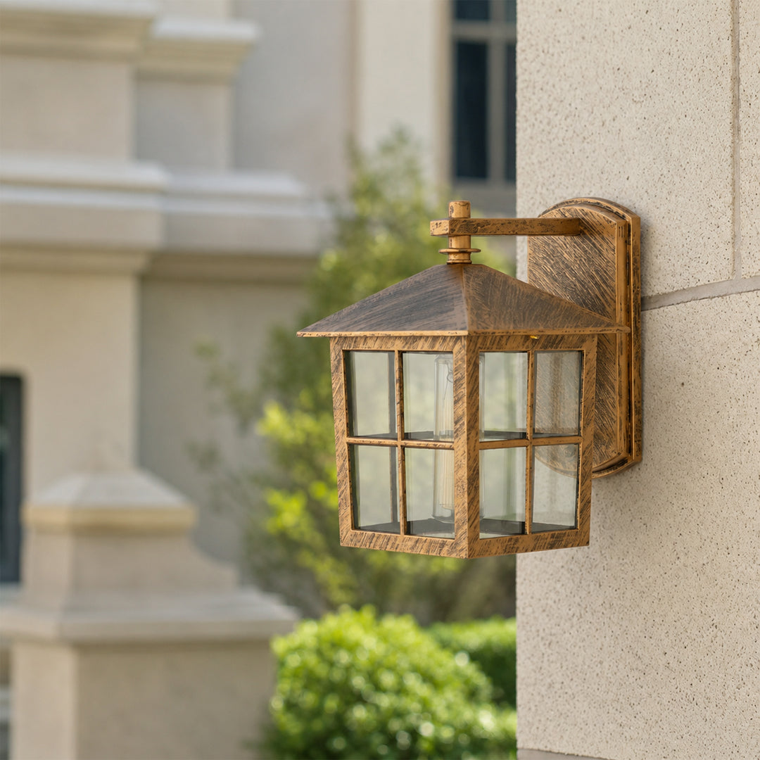 Antique brass outdoor wall lantern lifestyle image with windowpane glass shade mounted on an elegant stone column.