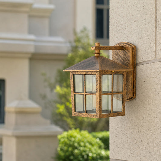 Antique brass outdoor wall lantern lifestyle image with windowpane glass shade mounted on an elegant stone column.