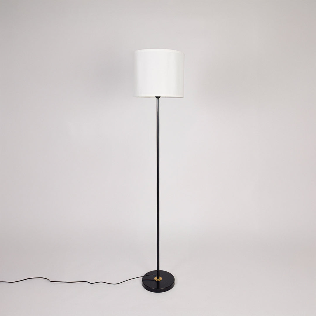 Black metal floor lamp with white fabric drum shade designed for modern living room bedroom and reading nook decor.