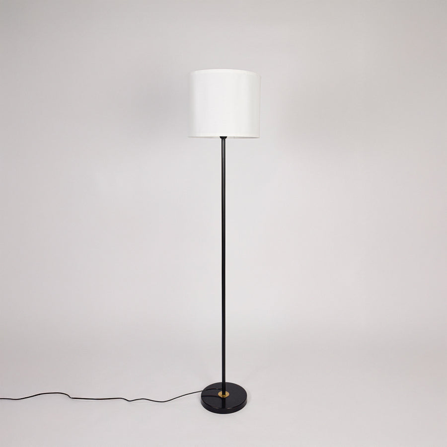 Black metal floor lamp with white fabric drum shade designed for modern living room bedroom and reading nook decor.