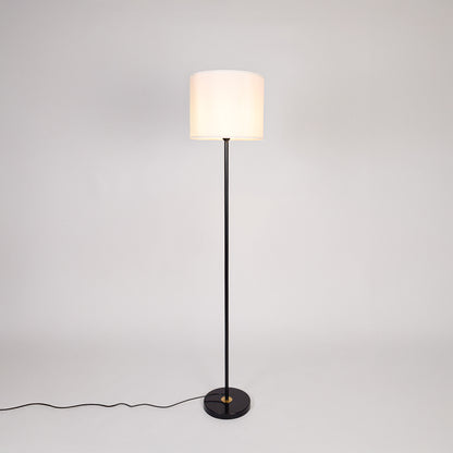 Black metal floor lamp with white fabric drum shade designed for elegant living room and bedroom lighting decor.